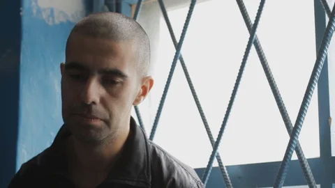 A prisoner sitting at the gate Stock Footage 73620113