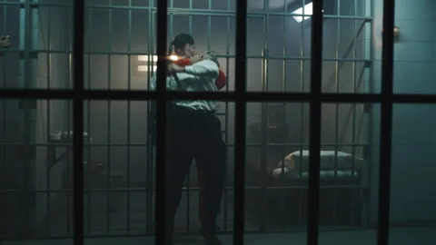 Prisoner strangles prison employee, takes keys and opens prison cell Stock Footage 246452613