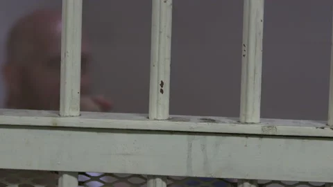 Prisoner Talking From Behind Bars 4K Stock Footage 145956984