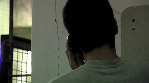 Prisoner Using Telephone in Detention Facility, Argentina, Close Up Vidéo 201646232