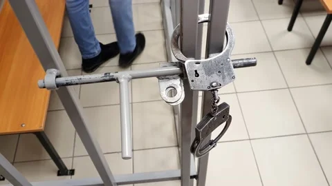 Prisoner walks in a cell handcuffs Video stock 145712635