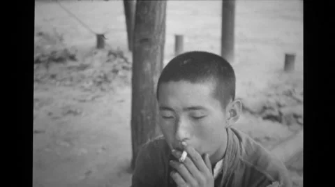 Prisoner of war smoking a cigarette Stock Footage