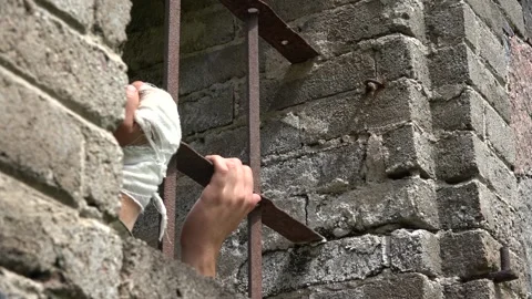 Prisoner of War at the window trying to escape Stock Footage 239753473