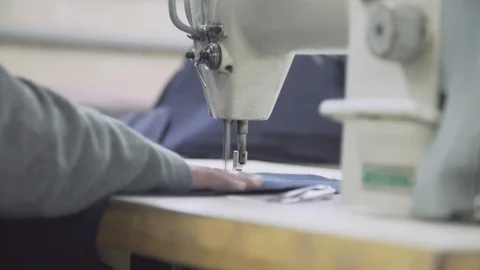 Prisoner working on sewing machine Stock Footage 127625345