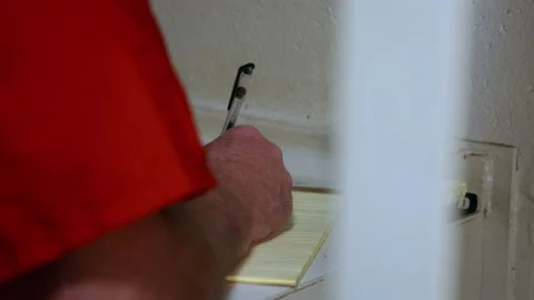 Prisoner writing in cell Stock Footage 202917993