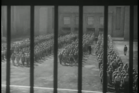 Prisoners congregated in prison yard Stock Footage