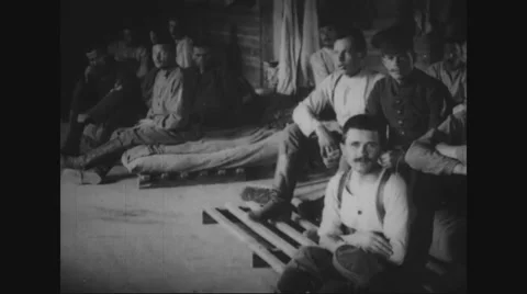 Prisoners sitting in prison camp Stock Footage 43317774