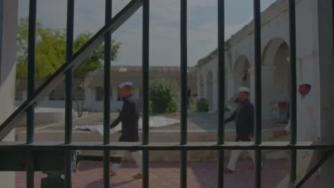 Prisoners walking on the lawn inside the prison india Video stock 222034518