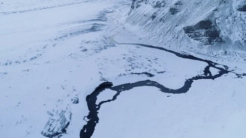 Pristine aerial flying over winter landscape: creek along side of a mountain. 库存影片 88225104