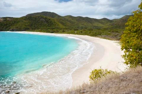 The pristine and hard to reach beach in the Rendezvous Bay in Antigua. Stock Photos