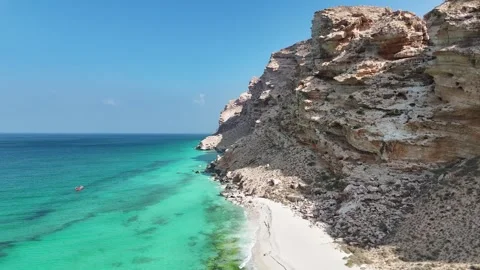 Pristine beach beside turquoise sea and rugged cliffs, Socotra siland Stock Footage 322019652
