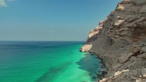 Pristine beach beside turquoise sea and rugged cliffs, Socotra siland Stock Footage 322019731