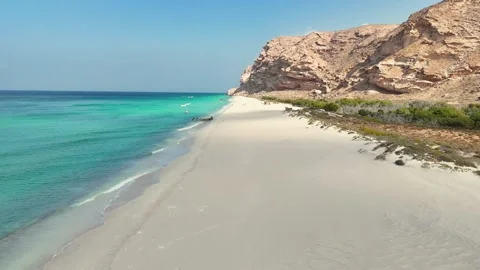Pristine beach beside turquoise sea and rugged cliffs, Socotra siland Stock Footage 322019875