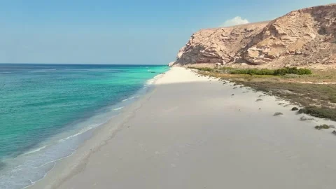Pristine beach beside turquoise sea and rugged cliffs, Socotra siland Stock Footage 322019937