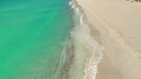 Pristine beach beside turquoise sea and rugged cliffs, Socotra siland Stock Footage 322019961