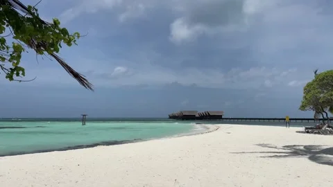 Pristine beach in Maldives overlooking water villas Stock-Footage 219961921