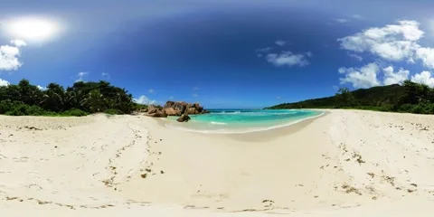Pristine beach with palm trees and rocks. La Digue, Seychelles. Stock Footage 310533617