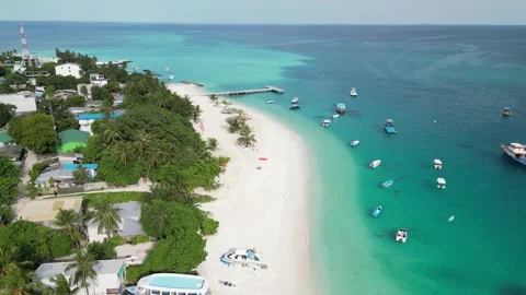 Pristine beach on tiny local island of Fulidhoo, Maldives. Aerial Stock Footage 259710646