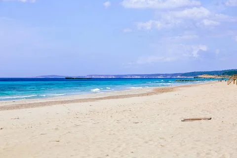 Pristine beach with turquoise ocean water under blue sky Stock Photos