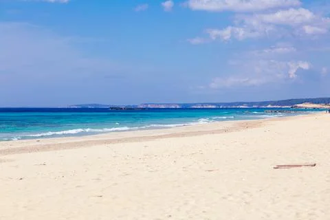 Pristine beach with turquoise ocean water under blue sky Stock Photos