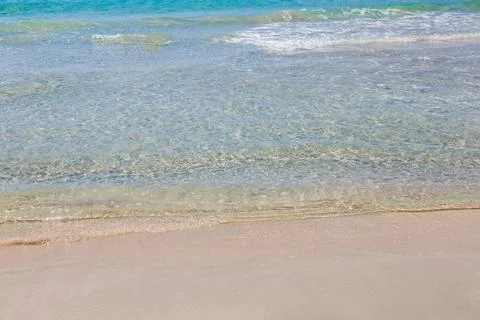 Pristine beach with turquoise ocean water under blue sky Stock Photos