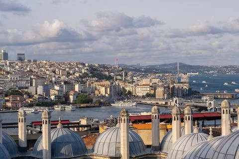 The pristine Bosphorus Strait is framed by colorful buildings and boats Stock Photos