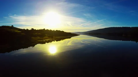 Pristine Calm lake glass reflections of blue sky sunset mountains 4k Aerial Stock Footage 60947483