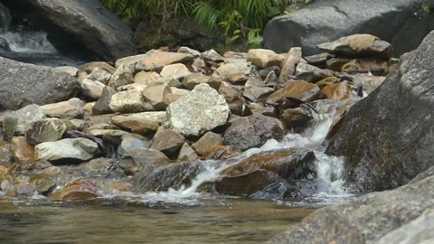 A pristine flowing water on beautiful rocks in a waterfall in Malaysia Stock Footage 155591636