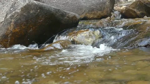 A pristine flowing water on beautiful rocks in a waterfall in Malaysia Stock Footage 155591798