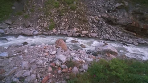 Pristine Glacial Waters of the Mandakini River flowing Over Stones in Himalayas Stock Footage 325013602