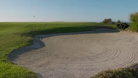 Pristine Golf Course Bunker with Raked Sand Patterns under Clear Skies Stock Footage 274386195