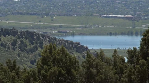 Pristine Lake Resting Behind Forested Hill Stock Footage 156215077