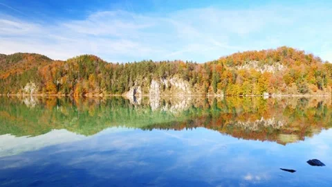 Pristine lake in southern Germany surrounded by fall forests and perfect mirr Stock Footage 309092142