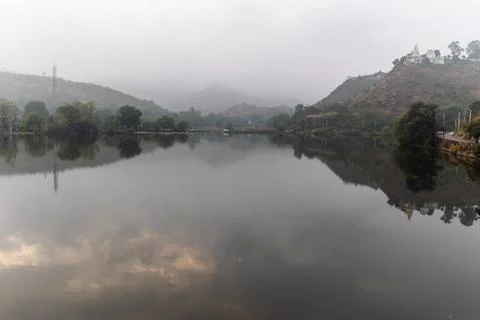 Pristine lake surrounded by green mountains at morning from flat angle Foto stock