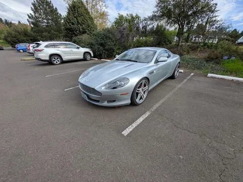 Pristine light blue Aston Martin DB9 Coupe parked on a sunny day Stock Photos