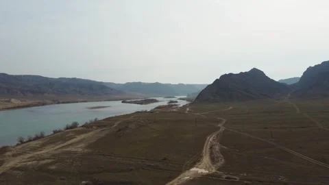 Pristine nature of Central Asia: view of a river in the endless spring steppe Stock Footage 331574049