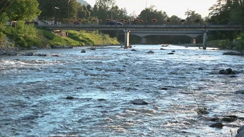 Pristine river flowing downstream under the bridge at warm summer evening Stock Footage 135047620