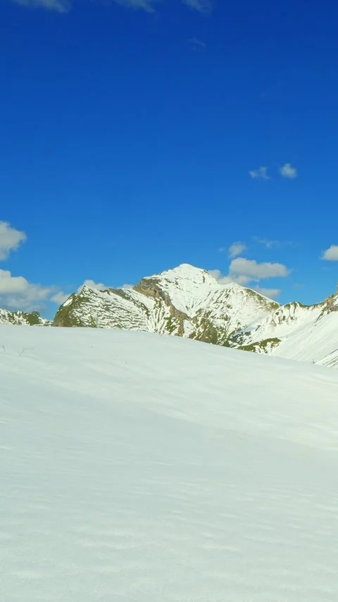 Pristine snowfield stretching below Rauheck summit in the heart of the Allgu Stock Footage 308295314