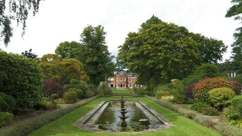 Pristine water feature and gardens revealing stately home, drone aerial 4K Stock Footage 101128645