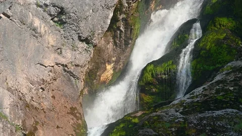 Pristine waterfall flowing downstream in Alps mountain Stock Footage 137152054