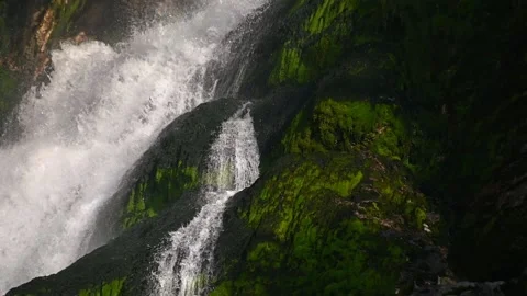 Pristine waterfall flowing downstream in Alps mountain Stock Footage 137152441