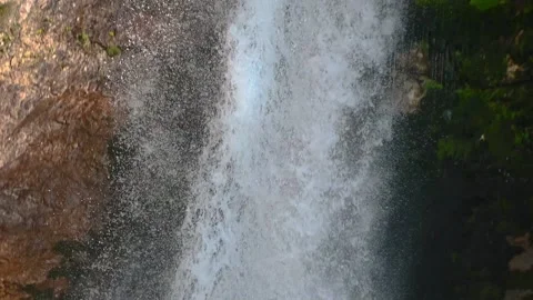 Pristine waterfall flowing downstream in Alps mountain Stock Footage 137152716