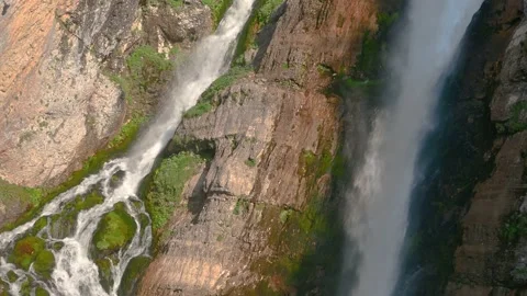 Pristine waterfall flowing downstream in Alps mountain Stock Footage 137153300