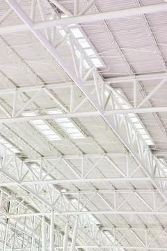 Pristine white ceiling with all white metal support beams and window skylights Stock-Fotos