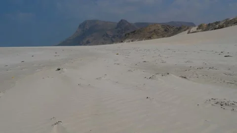 Pristine White Sand Beach with Turquoise Waters and Dramatic Coastal Mountains Vídeo Stock 336984873