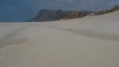 Pristine White Sand Beach with Turquoise Waters and Dramatic Coastal Mountains Stock Footage 336984941