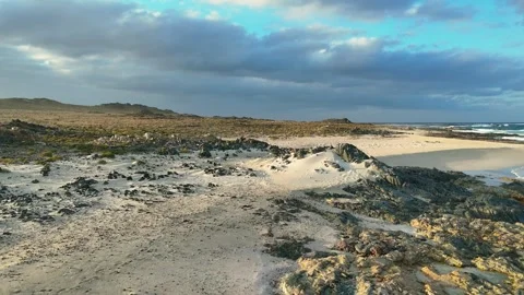 Pristine White Sand Beach with Turquoise Waters and Dramatic Coastal Mountains Video stock 337955659