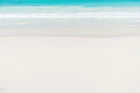 A pristine white sand beach with turquoise water lapping at the shore Stock Photos