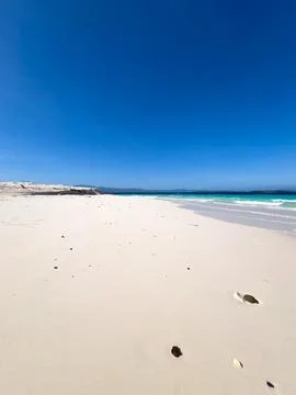 Pristine White Sand Beach Under Clear Blue Sky Stock Photos