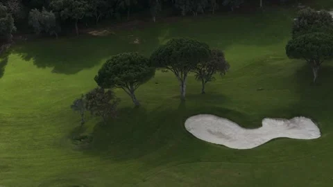 Pristine white sand bunker and manicured green fairway on a luxury golf course Stock Footage 328134683
